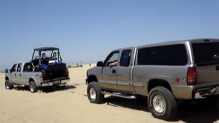 A Ford F-250 Pulls a Stranded RV-Hauling Chevy Through the Sand