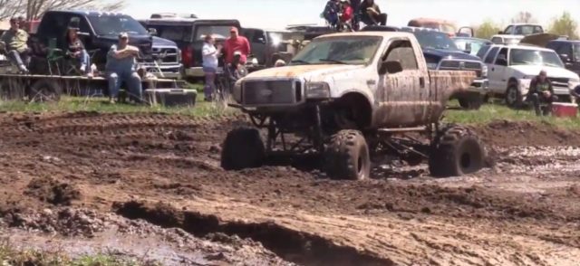 White Ford Super Duty Turning in Mud
